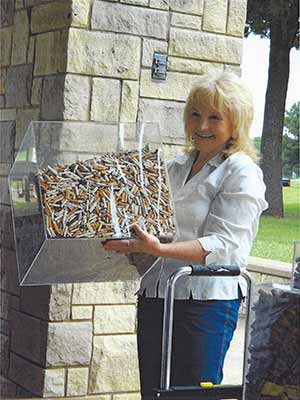 Crafty Casey holding cube of cigarette butts